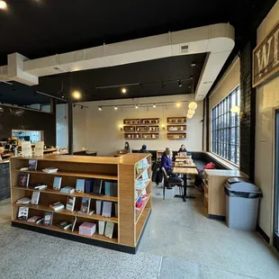 people sitting at tables in a coffee shop