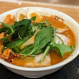 a bowl of ramen and a spoon