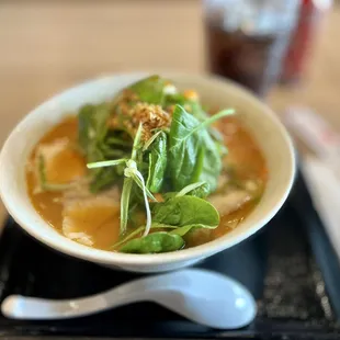 a bowl of ramen and a spoon