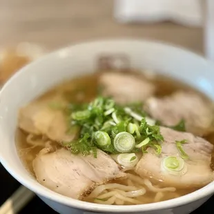 a bowl of ramen with meat and vegetables