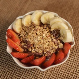  bowl of strawberries, bananas, and granola