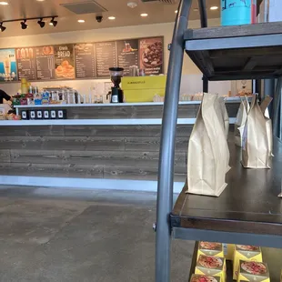 View from corner table, display rack right foreground and order counter in background