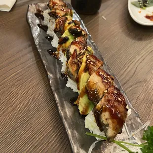 a sushi roll with meat and vegetables
