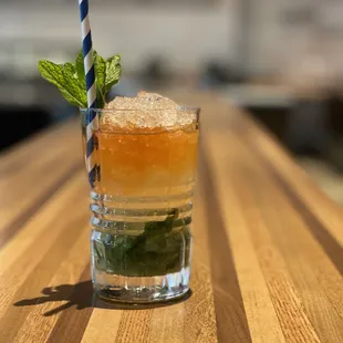 a drink with a straw and mint