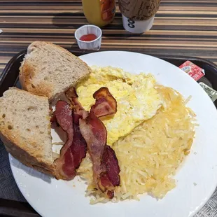 a breakfast of eggs, bacon and toast