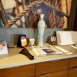 a picture of a kitchen counter with books and a vase on it