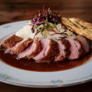 a plate of food with meat and rice