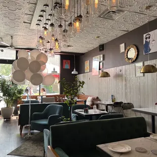 a dining area with green couches