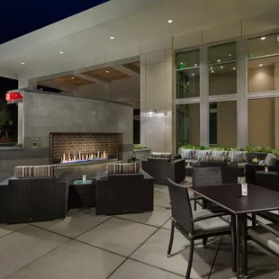 outdoor dining area with fireplace
