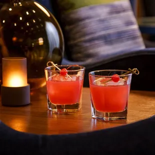 two glasses of cocktail on a table