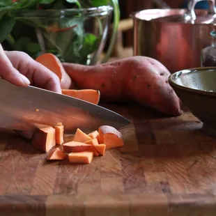 a person cutting carrots on a cutting board