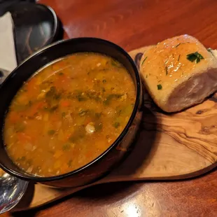a bowl of soup and a loaf of bread