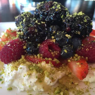 fresh berries with house made whipped cream, pistachios & organic honey