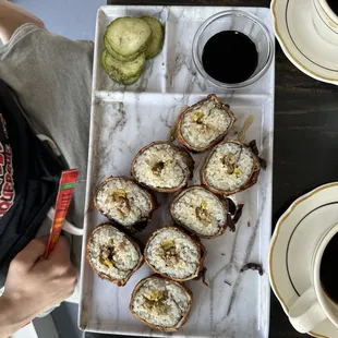 Cake Roll Sausage/eggs/everything bagel cream cheese in sushi wrapper dipped in thin pancake batter, quickly fried