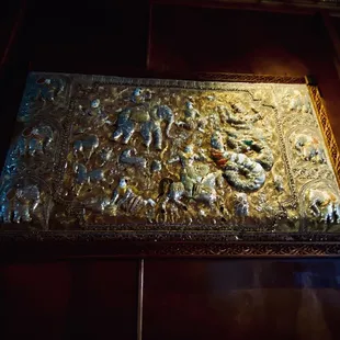 a gold tray with a picture of a dragon on it