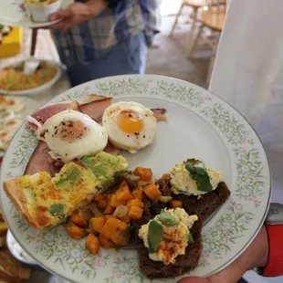 a person holding a plate of food