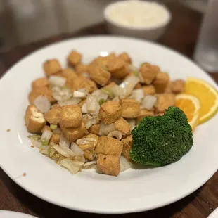 a plate of food with broccoli and tofu