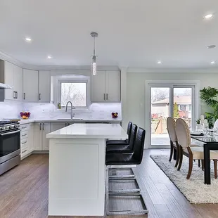 a kitchen with a dining table and chairs