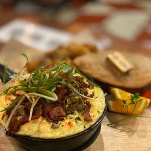 Soufflegg Skillet "Piggy": Minced pork, crispy bacon, scallion with crispy Yukon and rustic wheat toast
