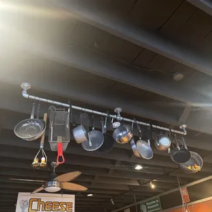 pots and pans hanging from ceiling