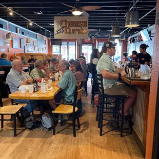 people sitting at tables in a restaurant