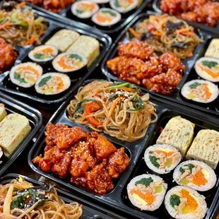 customized lunch boxes - fishcake gimbap, rolled egg omelet, popcorn chicken, and japchae