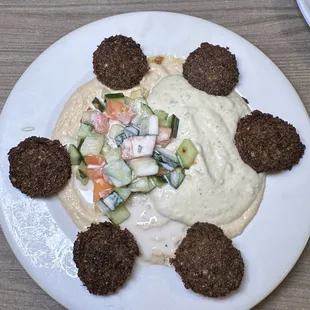 a plate of food with falafe and vegetables