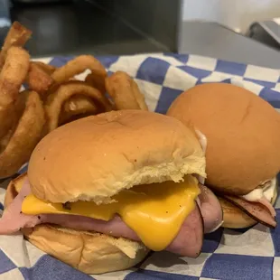 a ham and cheese sandwich with onion rings
