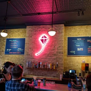 a neon sign above the bar