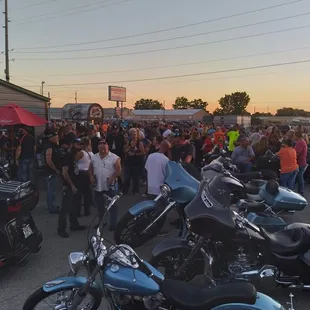 a large group of motorcycles parked in a parking lot