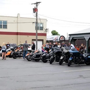 a line of motorcycles parked in a parking lot