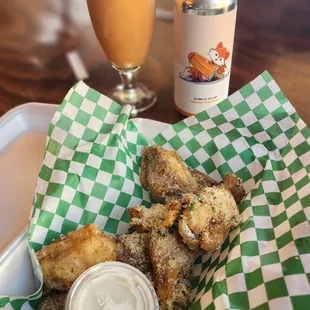 a basket of fried chicken and a drink