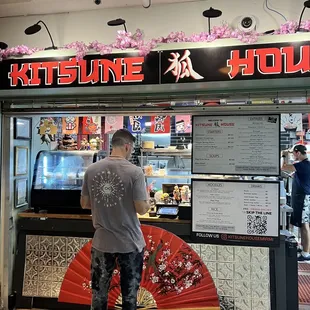 a man standing in front of a restaurant