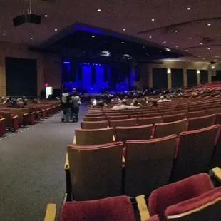 rows of red chairs and a stage