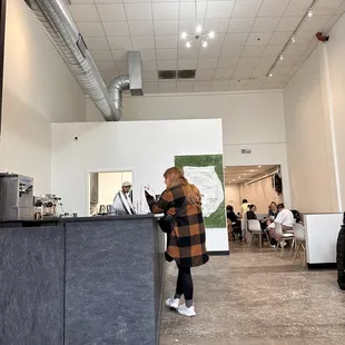 a woman standing at a counter in an office