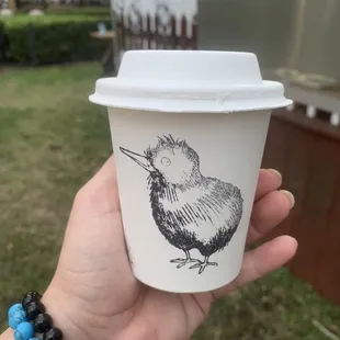 a hand holding a coffee cup