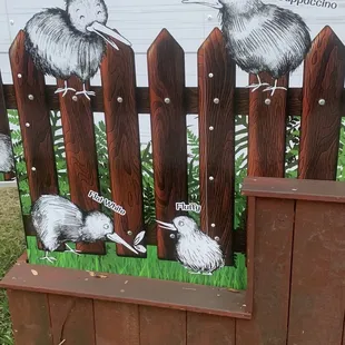 kiwis on a fence
