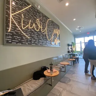 a coffee shop with a sign on the wall