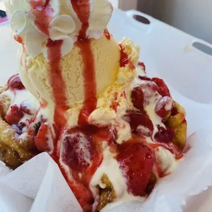 a piece of cake with whipped cream and strawberries