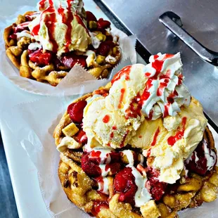 two waffles topped with ice cream and strawberries
