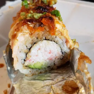 Baked salmon roll, side view. Tons of imitation crab, hardly any salmon to top it off and hardly any sauce for savory bites