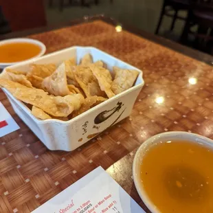 a bowl of tortilla and a bowl of soup on a table
