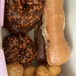 Halloween sprinkle donuts, donut holes, chocolate bar and custard filled bar.
