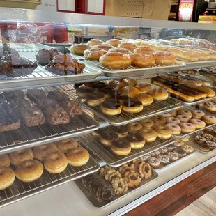 a variety of donuts in a display case