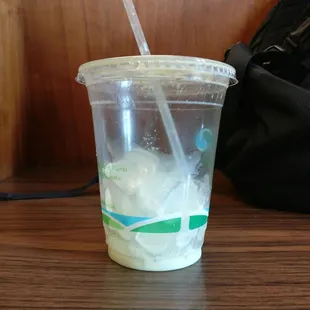 a plastic cup with a straw