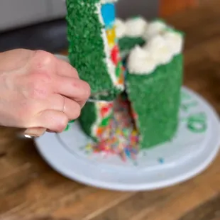 a person cutting a cake