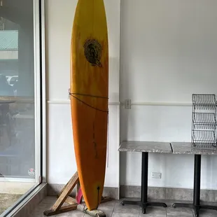 a surfboard leaning up against a wall