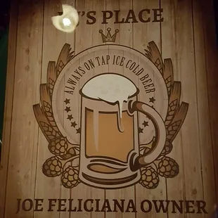 a wooden sign with a mug of beer