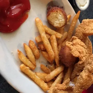 Fish plate served with fries and two hush puppies. Slaw also but not pictured.