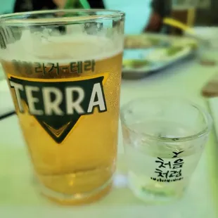 a glass of beer and a plate of food